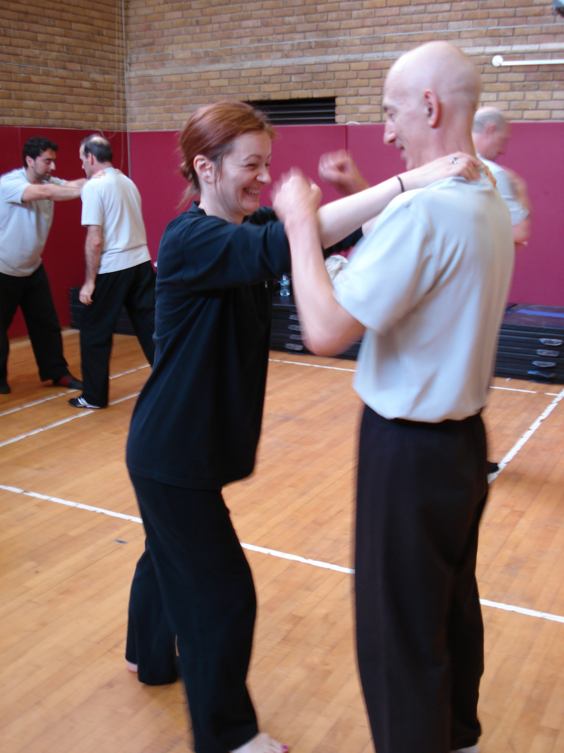 Zorica 'strangling' Dave in a workshop